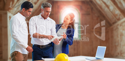 Composite image of architect discussing over tablet computer