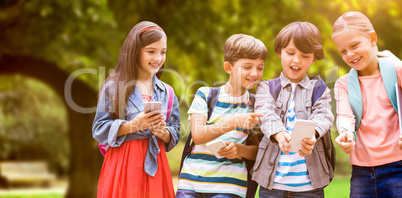 Composite image of boy with friends using mobile phone