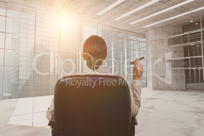 Composite image of rear view of female executive holding cigar