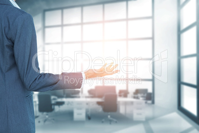 Composite image of businesswoman presenting