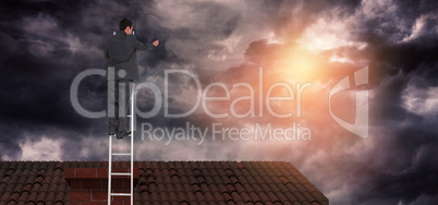 Composite image of businessman standing on ladder