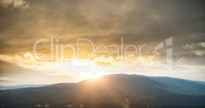 Mountains against cloudy sky during sunset