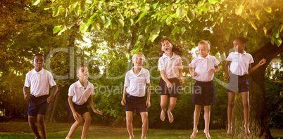 Composite image of happy students in school uniforms