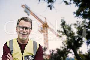 Composite image of portrait of senior worker wit arms crossed wearing reflective clothing