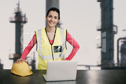 Composite image of portrait of female architect wearing reflective clothing