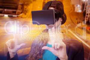 Composite image of young woman using virtual reality simulator over white background