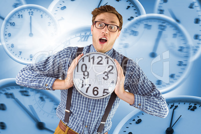 Composite image of geeky businessman holding a clock