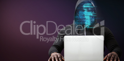 Composite image of male hacker with laptop on table