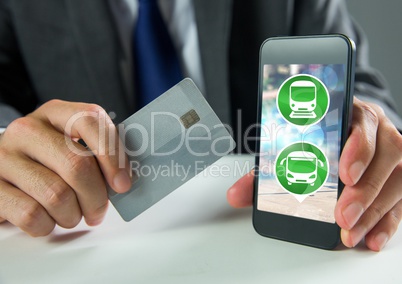 Hand holding phone with transport icons and bank card