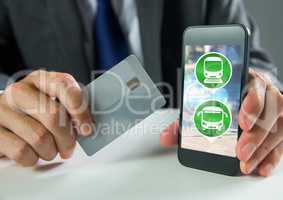 Hand holding phone with transport icons and bank card