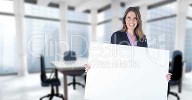 Business woman holding blank card in office