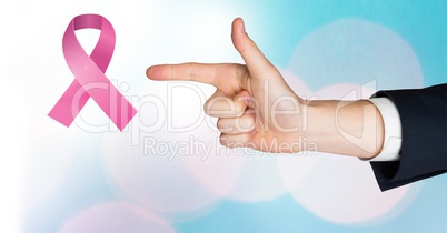 Pointing hand with pink ribbon for breast cancer awareness