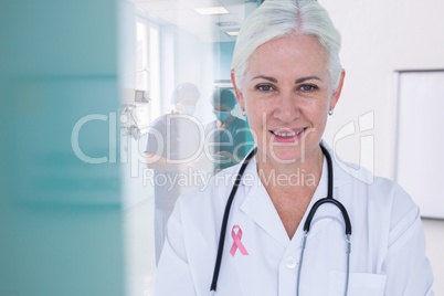 Doctor woman with breast cancer awareness ribbon