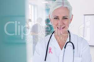 Doctor woman with breast cancer awareness ribbon