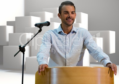 Businessman on podium speaking at conference with cubes