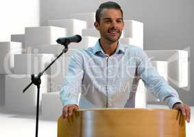 Businessman on podium speaking at conference with cubes