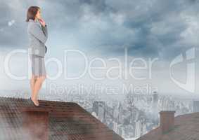 Businessman standing on Roof with chimney and cloudy city