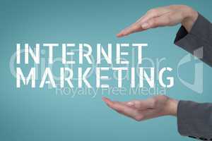 Hands interacting with internet marketing business text against blue background