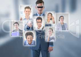 Businessman wearing Virtual reality headset interacting and choosing a person from group of people i