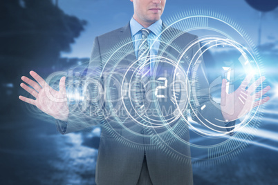 Composite image of businessman using futuristic digital screen