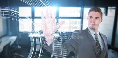 Composite image of businessman using futuristic digital screen