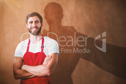 Composite image of portrait of smiling confident male owner with arms crossed