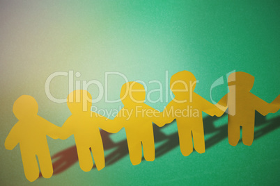Composite image of yellow hand holding paper