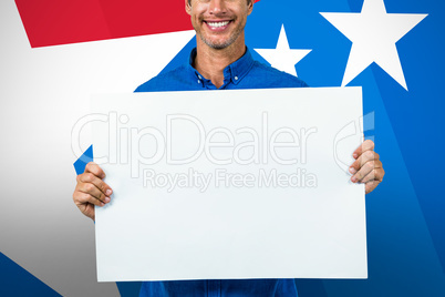 Composite image of portrait of happy man holding placard