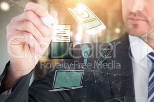 Composite image of serious businessman writing with marker