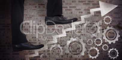 Composite image of low section of businessman climbing steps