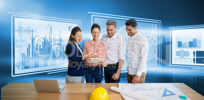 Composite image of architects discussing while standing by table