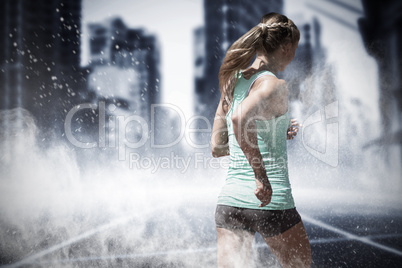 Composite image of rear view of sportswoman running on a white background