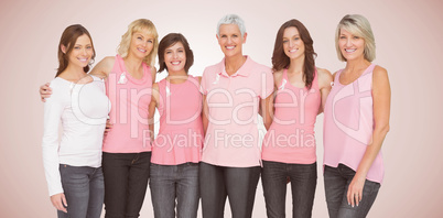 Composite image of portrait of smiling women supporting breast cancer social issue