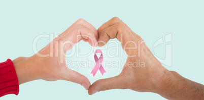 Composite image of couple making heart shape with hands