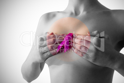 Nude woman with breast cancer ribbon