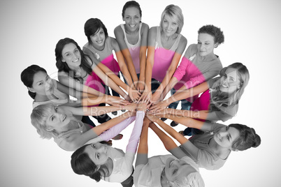 Portrait of happy female friends supporting breast cancer awareness