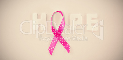 Overhead view of spotted Breast Cancer Awareness ribbon with HOPE text