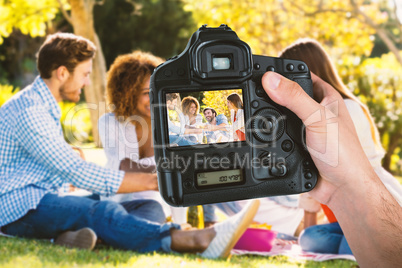 Composite image of cropped hand of photographer holding camera