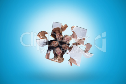 Composite image of happy women forming a huddle