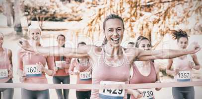 Smiling women running for breast cancer awareness