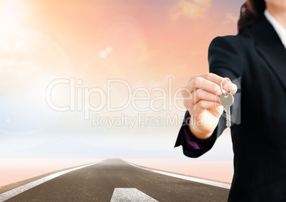Woman  Holding key in front of road