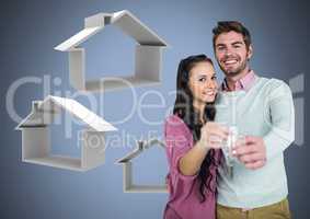 Couple Holding key with house icons in front of vignette