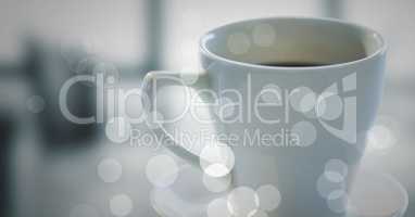 White coffee cup and bokeh against blurry grey office