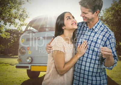Couple  Holding key in front of camper van