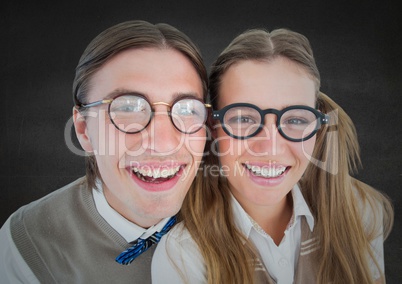 Close up of nerd couple against grey wall