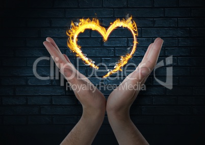 hands with heart fire icon over. Dark bricks wall background