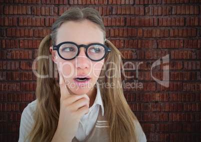 Close up of nerd woman thinking against brick wall