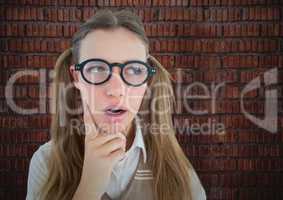 Close up of nerd woman thinking against brick wall