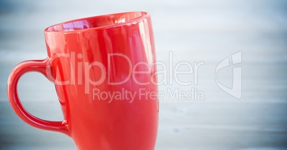 Red cup against blurry blue wood panel