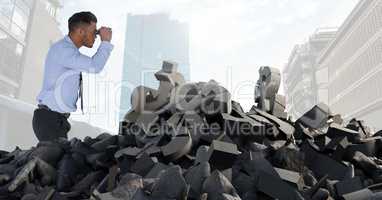 Broken concrete stone with money symbol and businessman with binoculaurs in cityscape